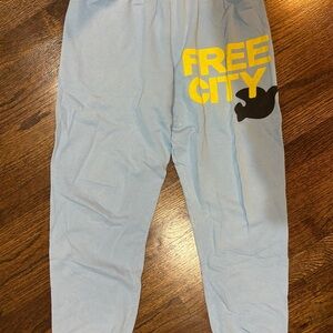 freecity woman’s Sky Blue Joggers with Yellow Logo in excellent condition